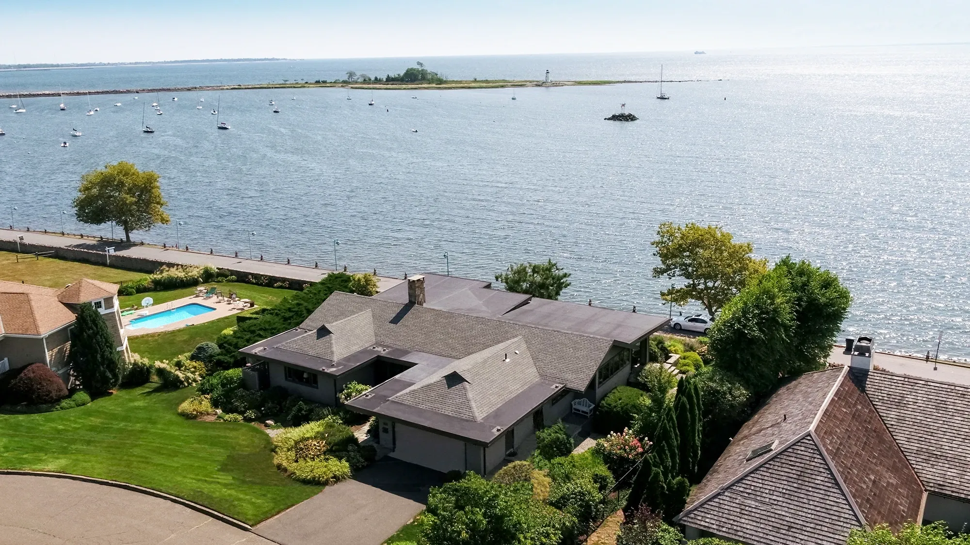 Aerial view of a waterfront home in Black Rock, Bridgeport CT, overlooking the harbor and Fayerweather Island Lighthouse